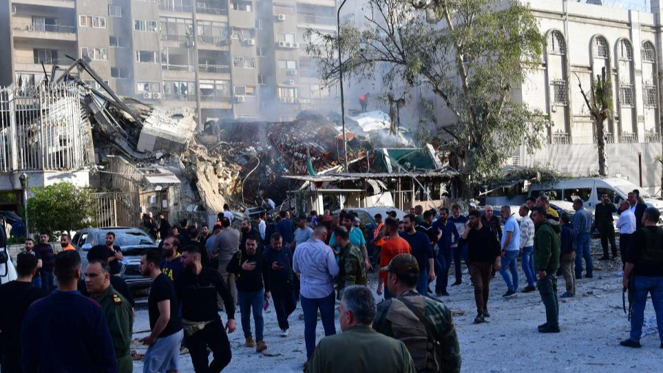 People gather at the site of an Israeli missile attack targeting the building of the Iranian Consulate in Damascus, Syria, April 1, 2024. /Xinhua