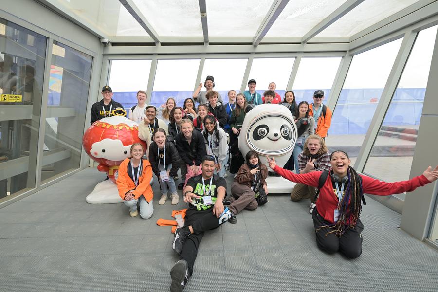 Members of a delegation of high school students from the U.S. state of Washington pose for a photo with mascots of the Beijing 2022 Olympic Winter Games and the Beijing 2022 Paralympic Winter Games, in Beijing, China, March 21, 2024. /Xinhua