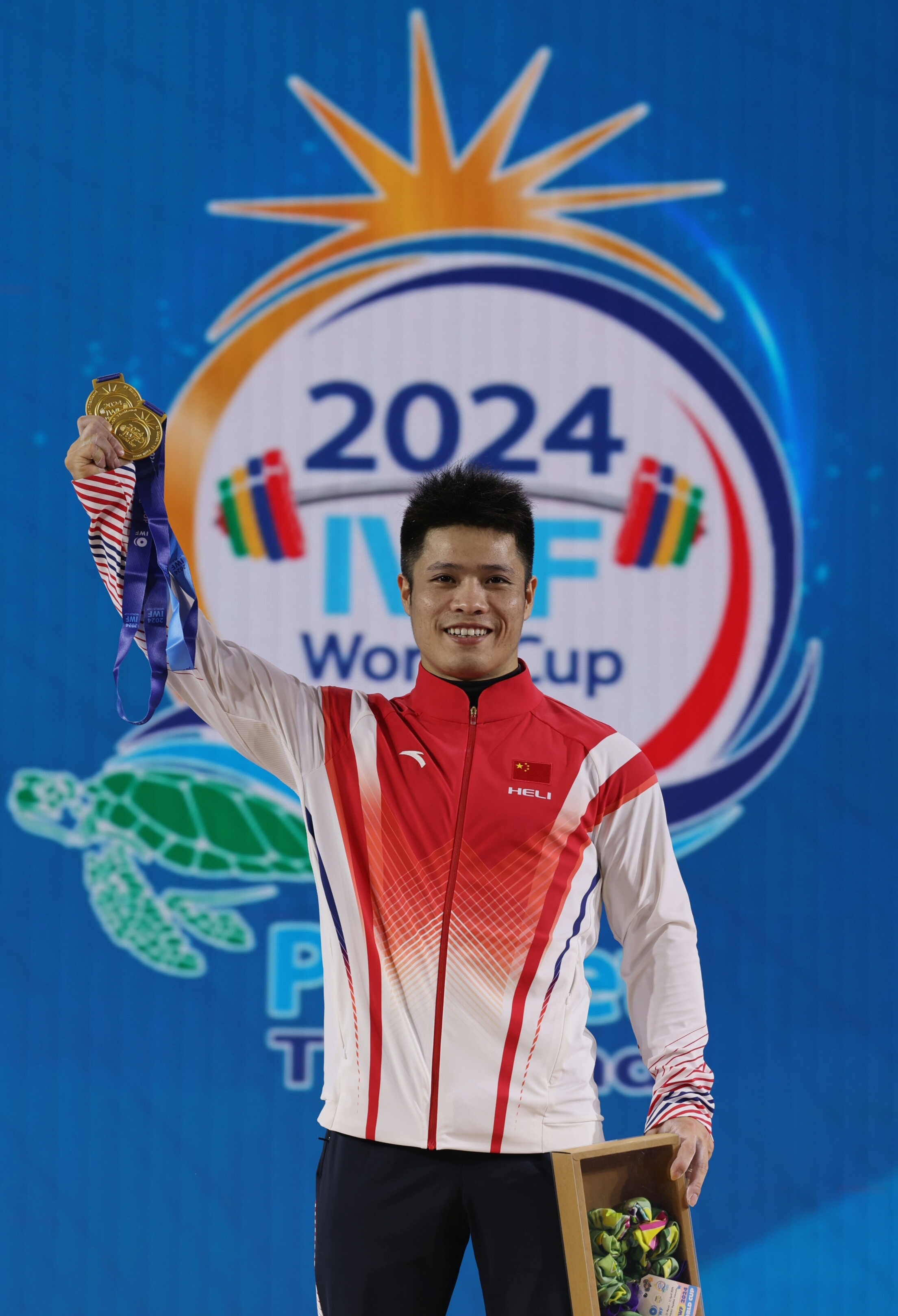 China's Li Fabin during the medal ceremony of the men's 67 kg weightlifting event at the IWF World Cup in Phuket, Thailand, April 2, 2024. /CFP