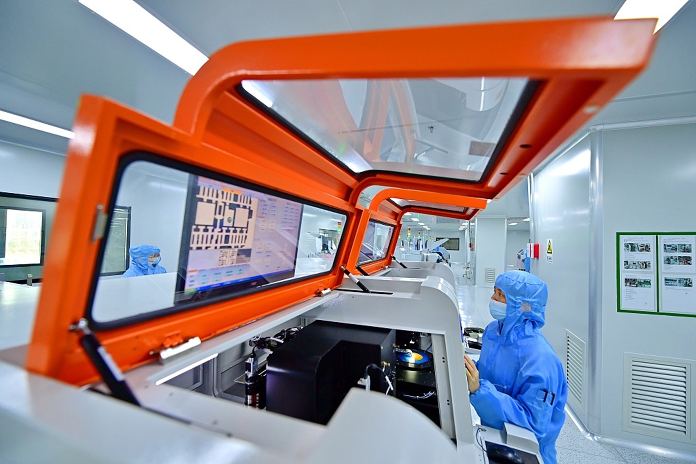 A technician operates automated equipment for chip production and packaging at a semiconductor factory in Jiujiang, east China's Jiangxi Province, March 21, 2024. /CFP
