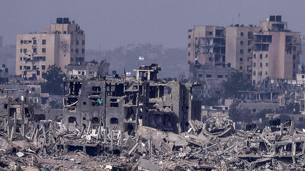 An Israeli flag flies over destroyed buildings inside the Gaza Strip, November 19, 2023. /CFP