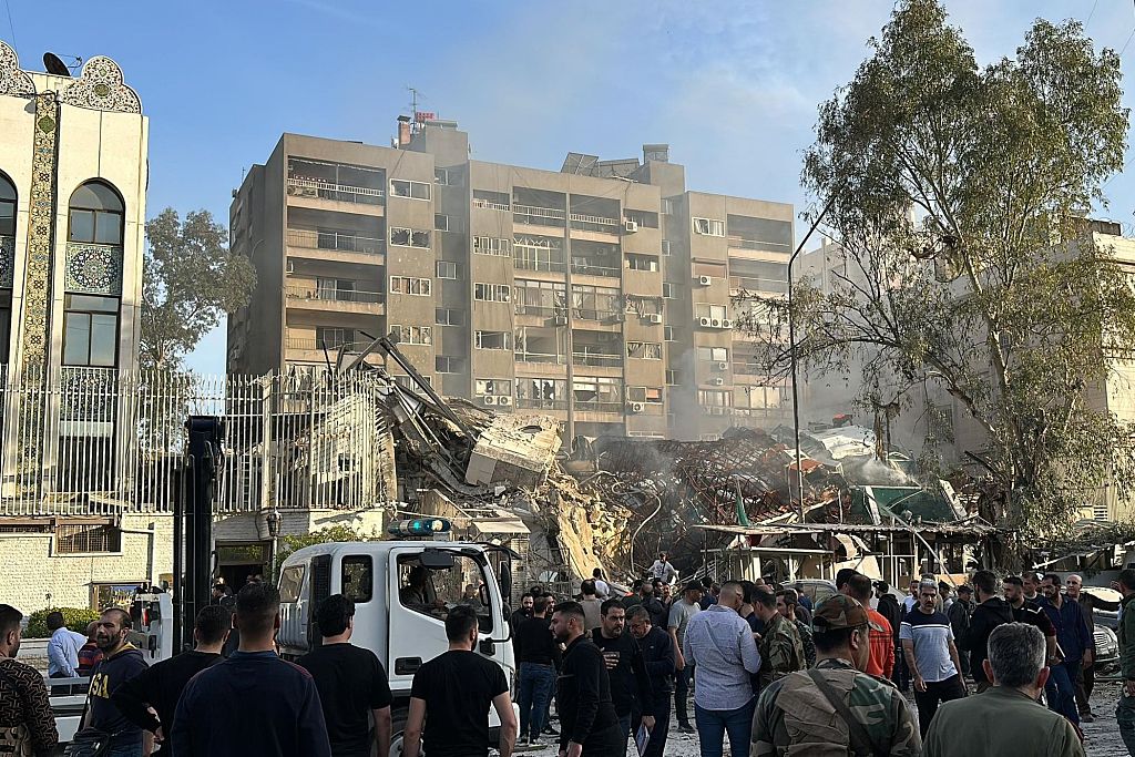 Emergency and security personnel gather at the site of strikes which hit a building adjacent to the Iranian embassy in Syria's capital, Damascus, April 1, 2024. /CFP