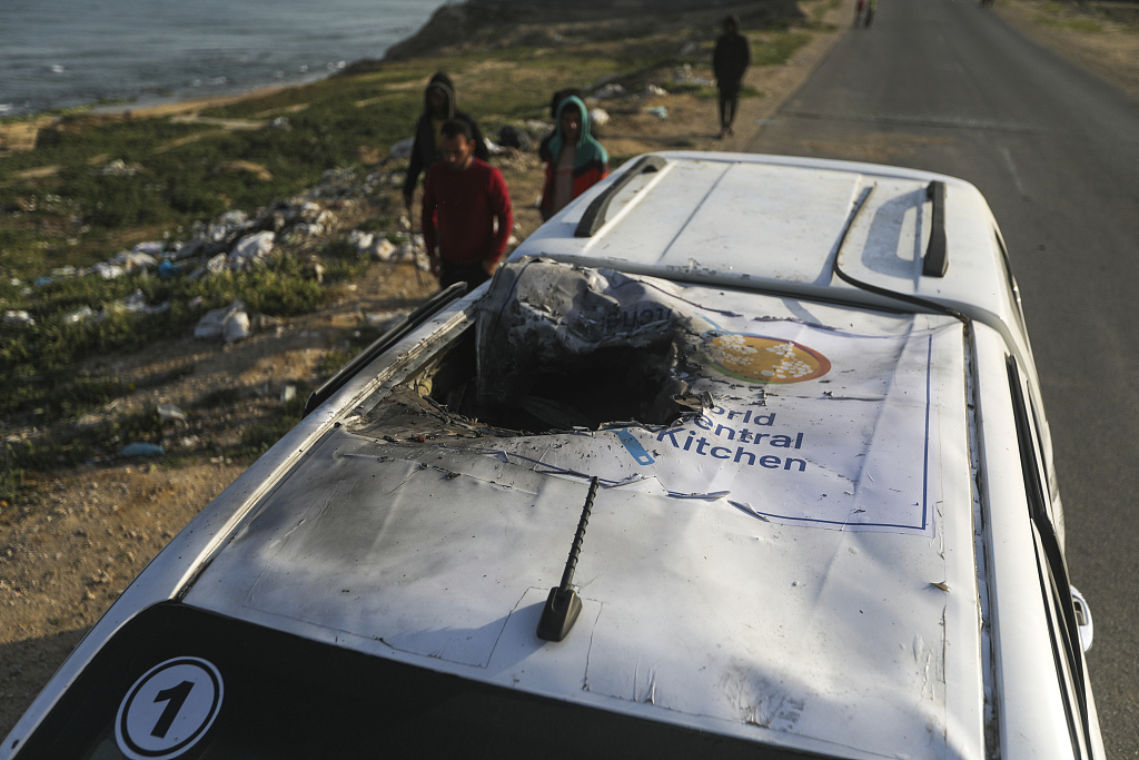 Palestinians inspect a vehicle with the logo of the World Central Kitchen wrecked by an Israeli airstrike in Deir al Balah, Gaza Strip, April 2, 2024. A series of airstrikes killed seven aid workers from the international charity, leading it to suspend delivery of vital food aid to Gaza on April 2. /CFP