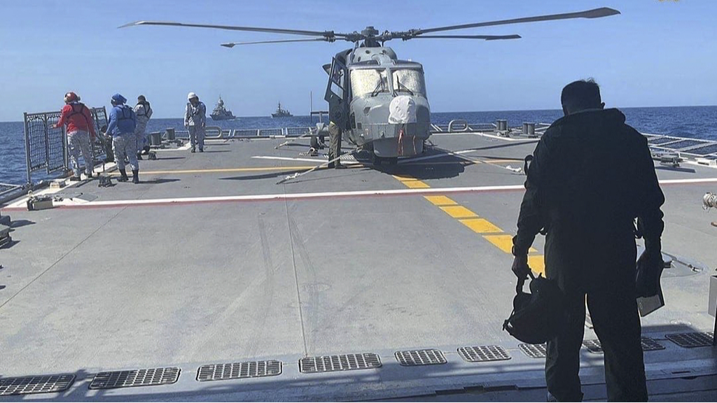 A Philippine Navy helicopter pilot walks toward the helideck to conduct his pre-flight inspection procedure on the helicopter during the first Multilateral Maritime Cooperative Activity at in the South China Sea, April 7, 2024. /CFP