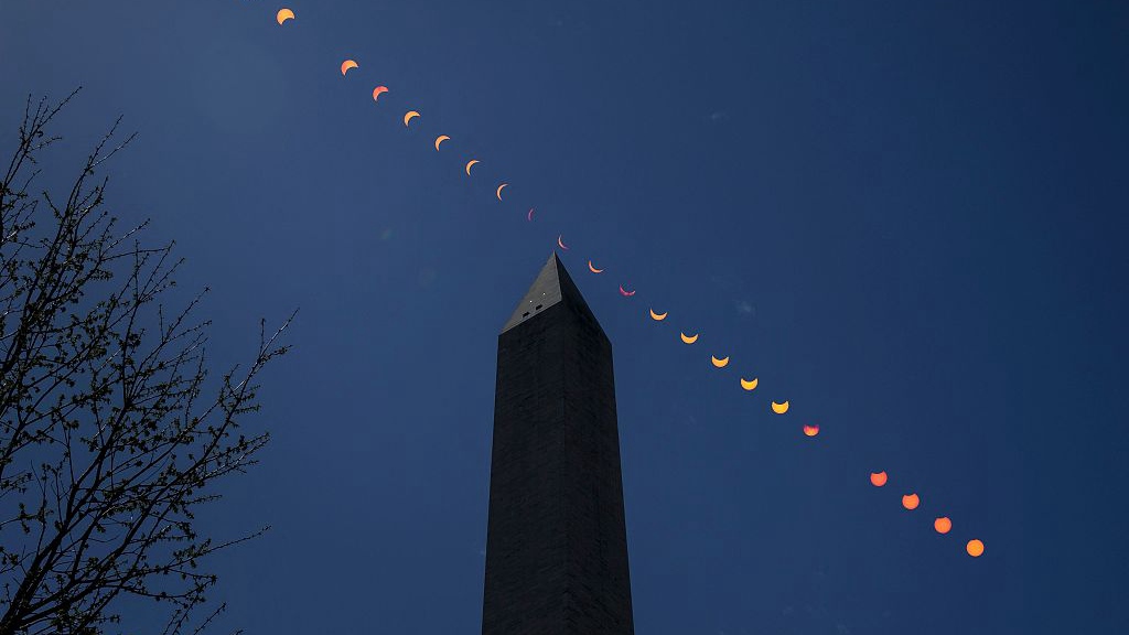 A composite image showing the progression of a partial solar eclipse over the Washington Monument, in Washington, D.C., the U.S., April 8, 2024.  /NASA