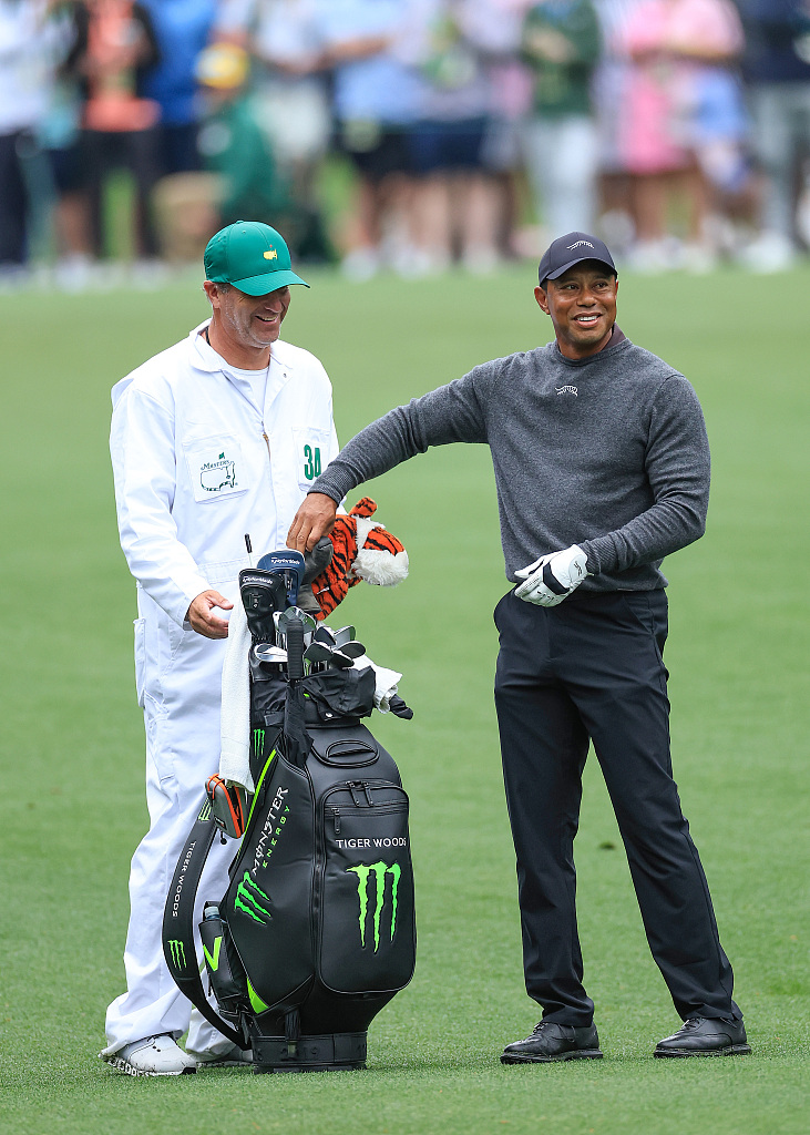 American golfer Tiger Woods (R) prepares to play a shot during a practice round with his caddie Lance Bennett ahead of the Masters Tournament at Augusta National Golf Club in Augusta, Georgia, U.S., April 9, 2024. /CFP