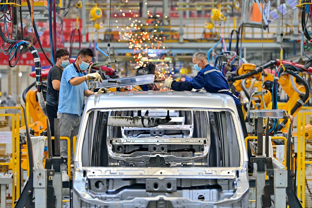 Workers welding carriage frames on the assembly line at a car manufacturing company in Ganzhou New Energy Automobile City, Jiangxi Province, China, April 9, 2024. /CFP