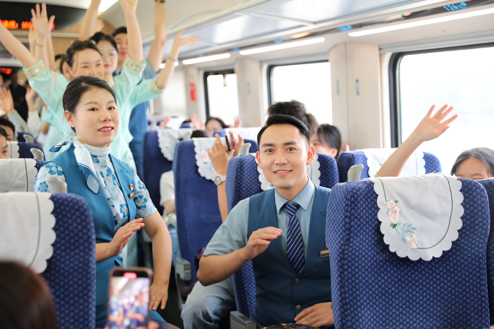 Train staff greet passengers at Xishuangbanna Railway Station, southwest China's Yunnan Province, April 13, 2024. /CGTN