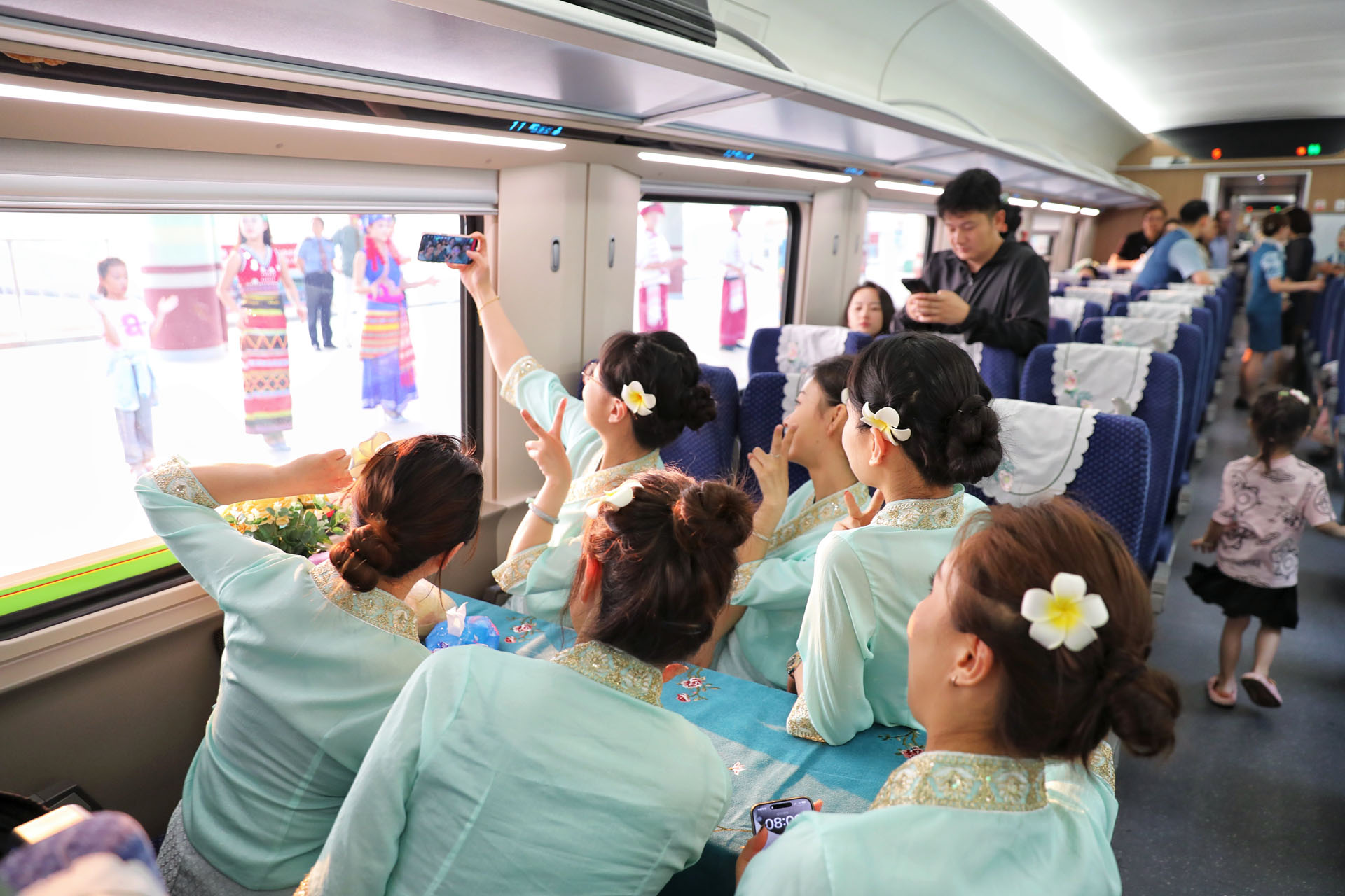Train staff take a selfie on a high-speed rail car at Xishuangbanna Railway Station, southwest China's Yunnan Province, April 13, 2024. /CGTN