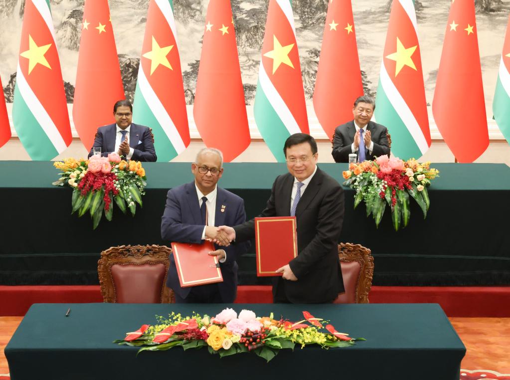 Chinese President Xi Jinping (R, back) and President of the Republic of Suriname Chandrikapersad Santokhi witness the signing of several bilateral cooperation documents in Beijing, capital of China, April 12, 2024. /Xinhua 