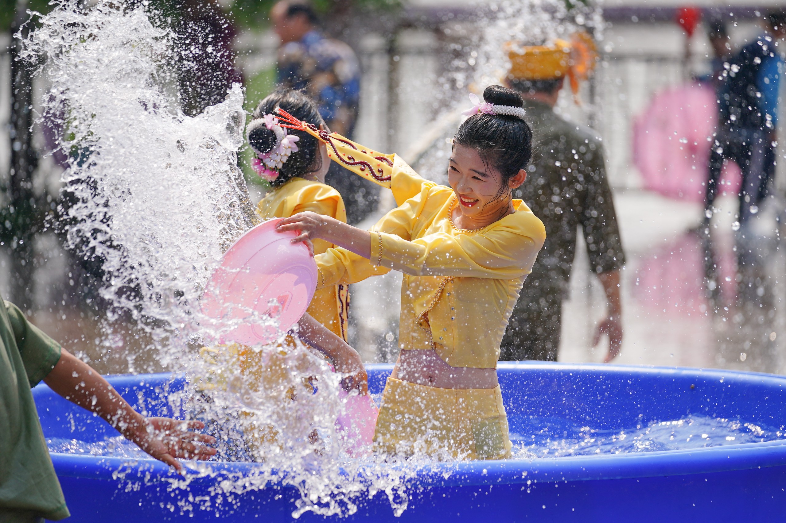 People splash water on each other to wish for good fortune during the traditional water-splashing festival held at an ethnic village in Kunming, southwest China's Yunnan Province, April 12, 2024. /IC