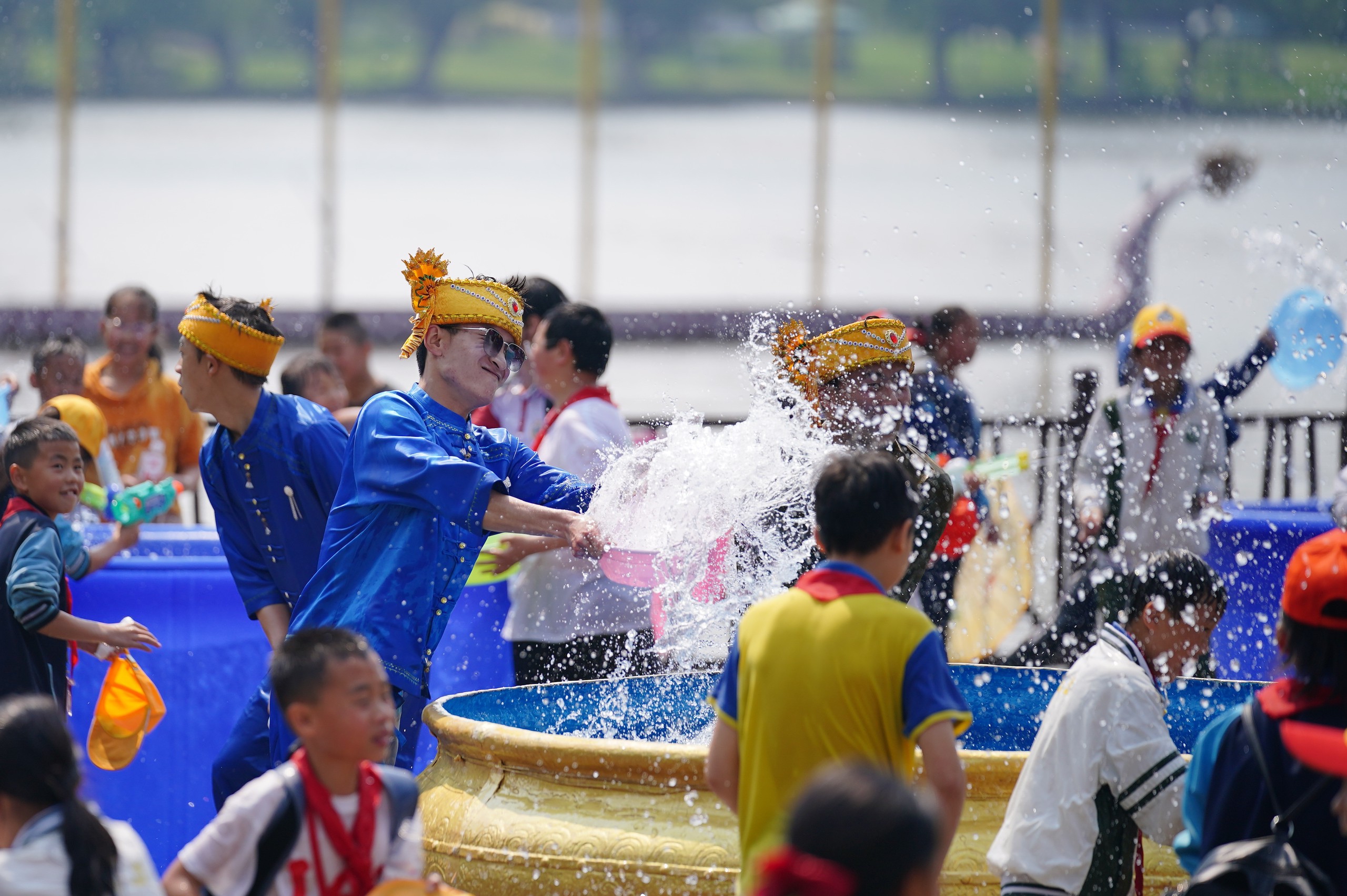 People splash water on each other to wish for good fortune during the traditional water-splashing festival held at an ethnic village in Kunming, southwest China's Yunnan Province, April 12, 2024. /IC