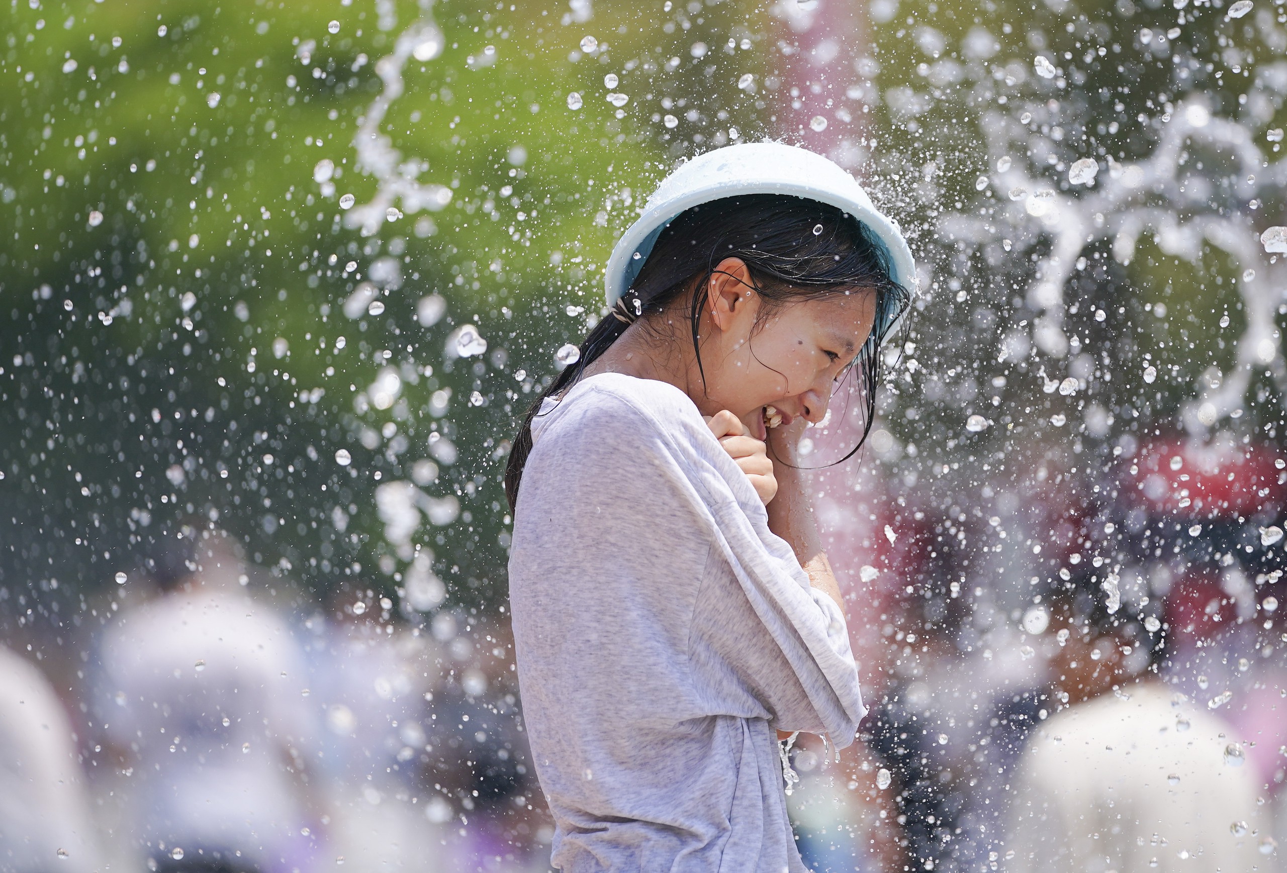 A woman is soaked during the traditional water-splashing festival held at an ethnic village in Kunming, southwest China's Yunnan Province, April 12, 2024. /IC