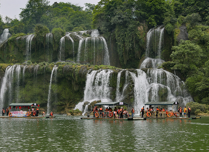 People enjoy their leisure time at the Detian Waterfall tourist spot in Daxin County, south China's Guangxi Zhuang Autonomous Region on April 13, 2024. /CFP