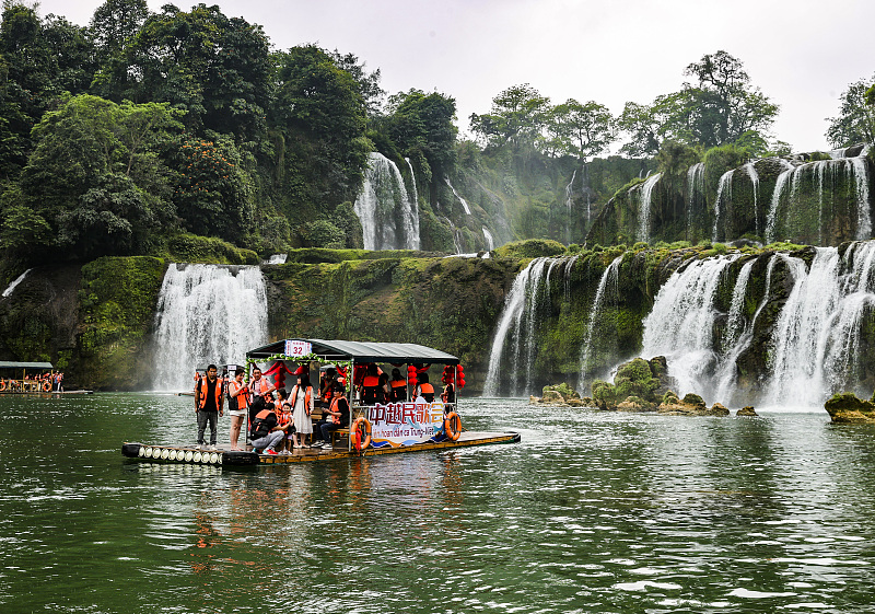 People enjoy their leisure time at the Detian Waterfall tourist spot in Daxin County, south China's Guangxi Zhuang Autonomous Region on April 13, 2024. /CFP