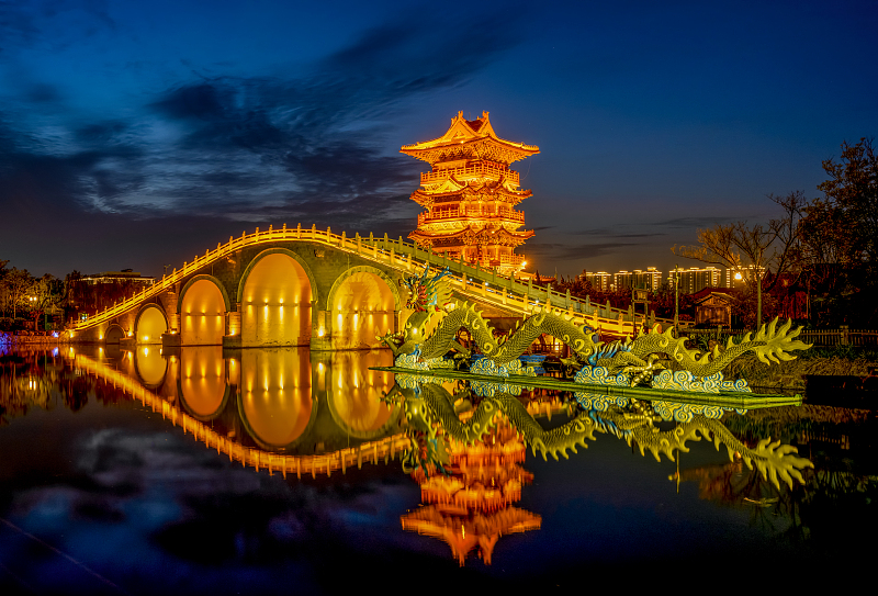 Millennium City Park is illuminated by colorful lights at night in Kaifeng City, Henan Province. /CFP