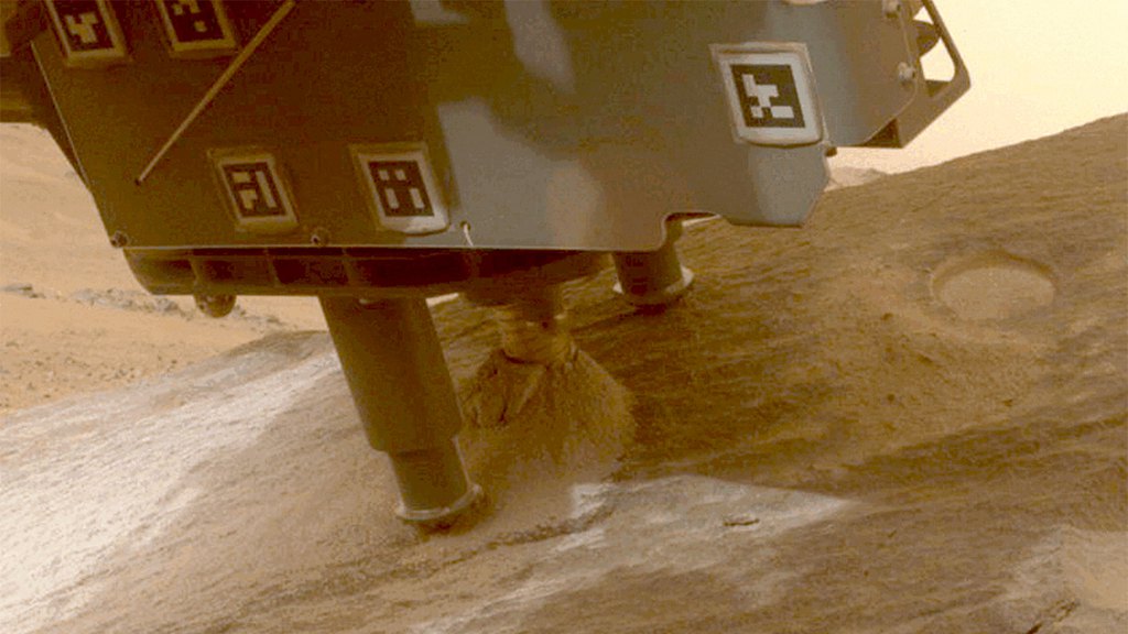 The Perseverance Mars rover collecting a sample from a rock called 