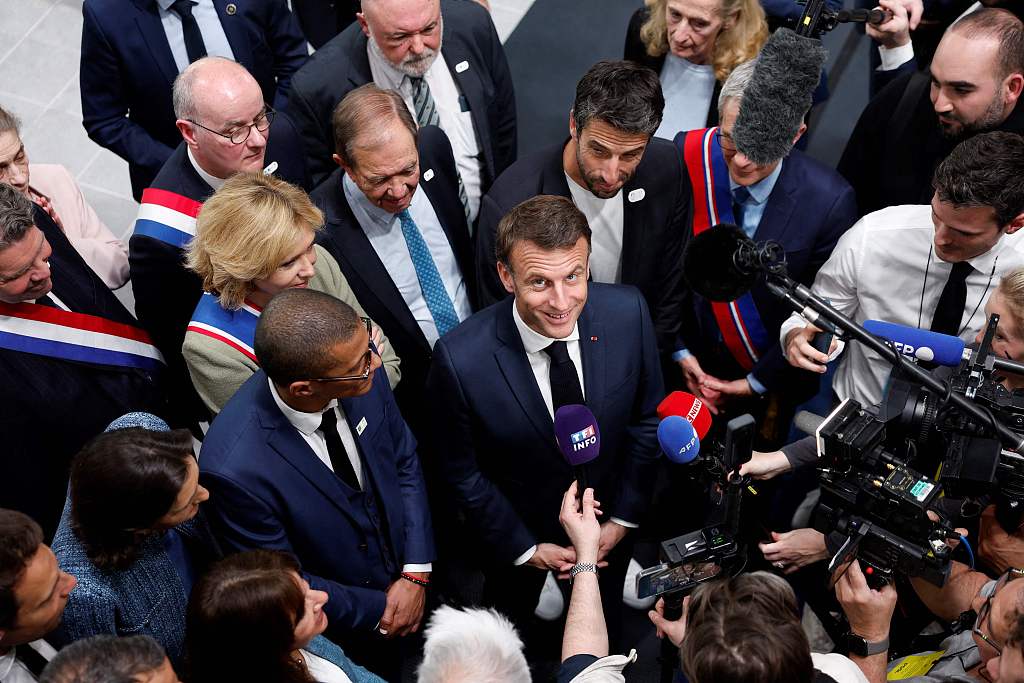 French President Emmanuel Macron talks to journalists during the inauguration of the Olympic aquatics center, a multifunctional venue for the Paris 2024 Olympics, in Saint-Denis outside Paris, France, April 4, 2024. /CFP 