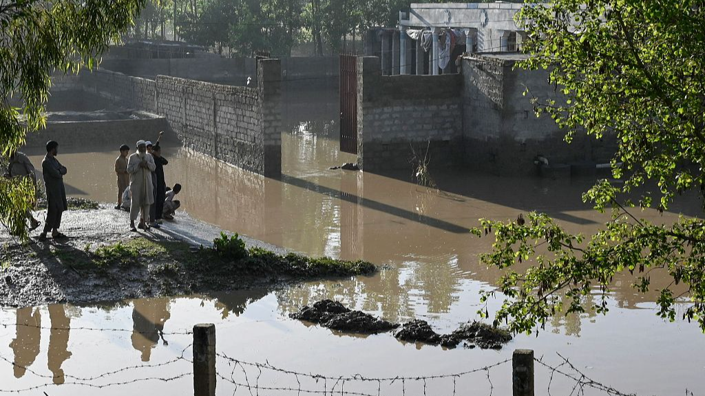 Residents stand near flooded homes following heavy rains in Charsadda district of Khyber Pakhtunkhwa, Pakistan, April 17, 2024. /CFP