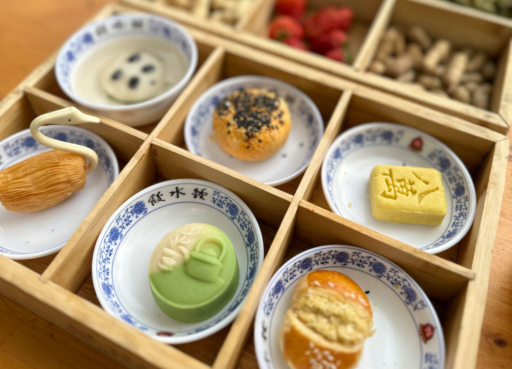 Fine tea snacks are seen neatly arranged in a nine-grid pattern at the Heming Teahouse in Chengdu in this photo taken in March 2024. /CGTN