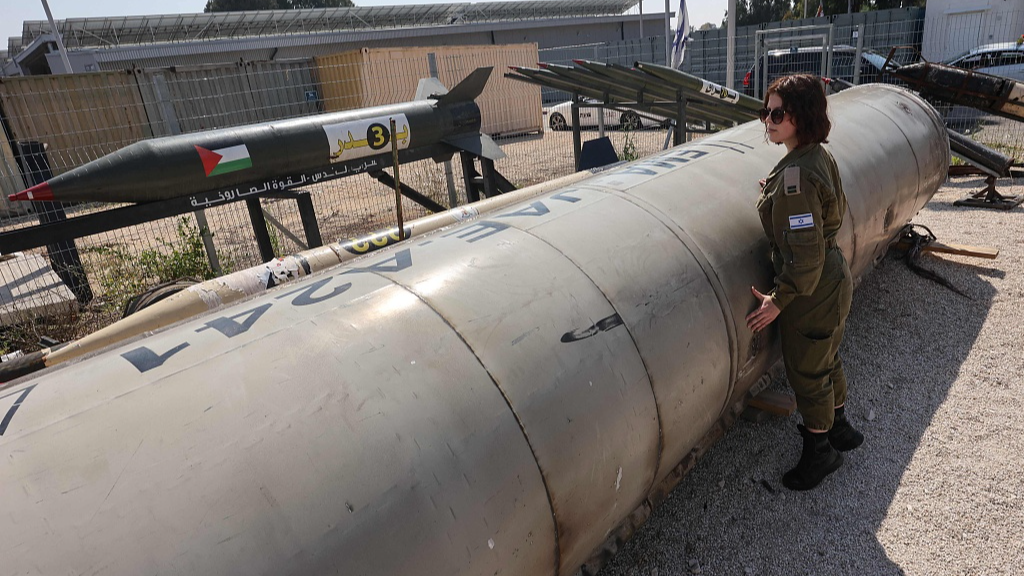 A member of the Israeli military stands next to an Iranian ballistic missile which fell in Israel on the weekend, during a media tour at the Julis military base near the city of Kiryat Malachi, Israel, April 16, 2024. /CFP