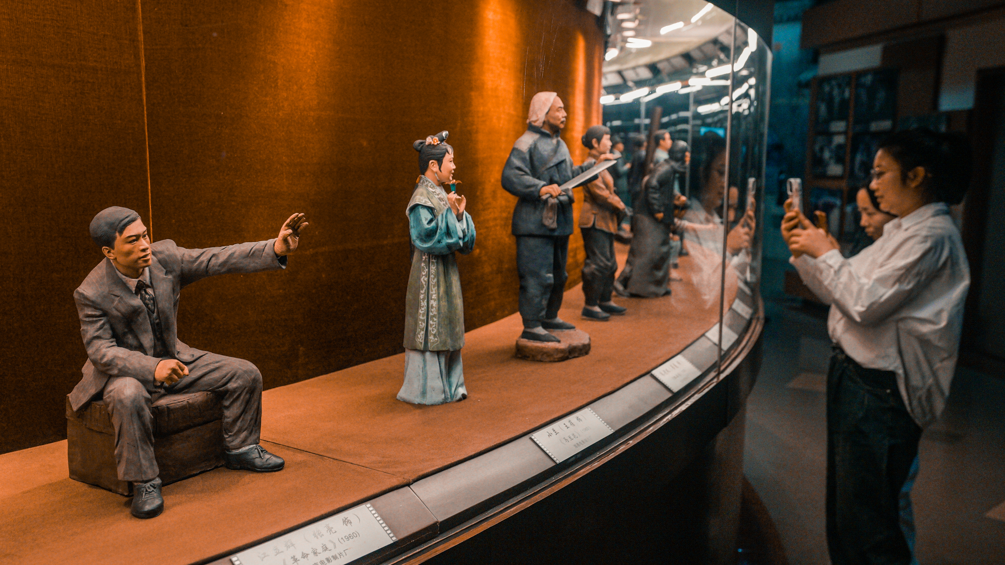 Visitors take photos of clay movie figure sculptures at the China National Film Museum. April 16, 2024 Chen Bo/CGTN 