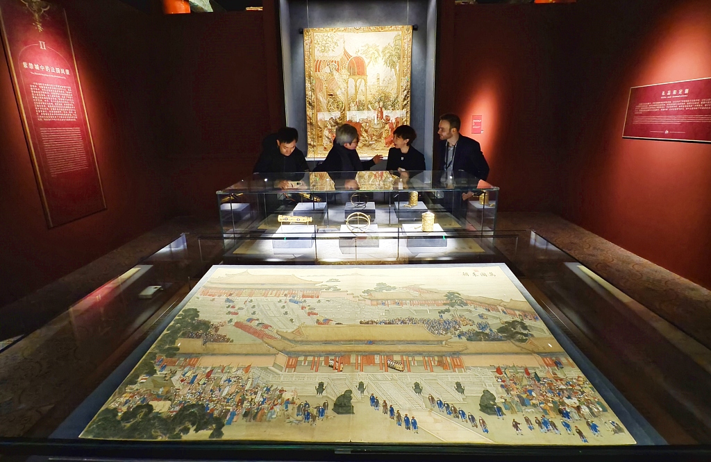Visitors appreciate the exhibits during an exhibition on the exchanges between China and France in the 17th and 18th centuries at the Palace Museum in Beijing on April 1, 2024. /CFP 
