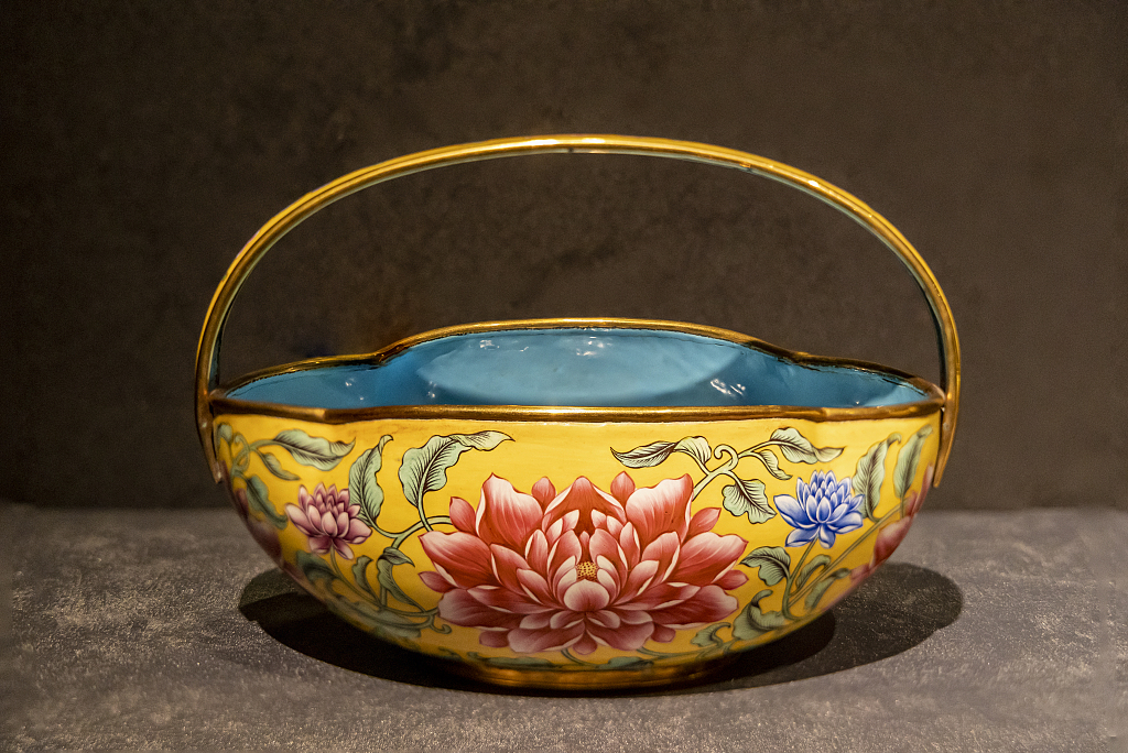 A painted enamel basket decorated with peony patterns is on display at an exhibition at the Palace Museum in Beijing on April 14, 2024. /CFP 