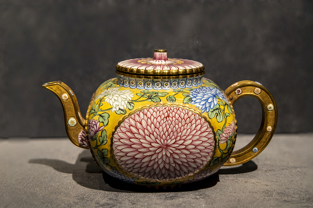 A painted enamel pot decorated with chrysanthemum patterns is on display during an exhibition at the Palace Museum in Beijing on April 14, 2024. /CFP 