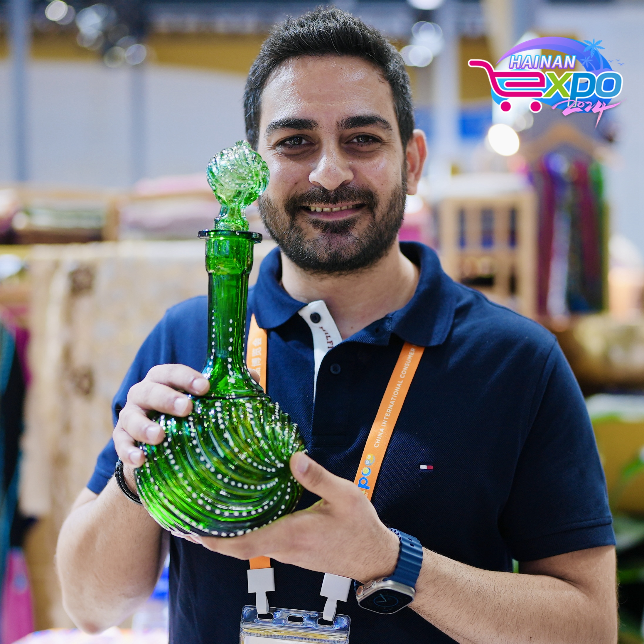 An exhibitor from Syria poses for a photo at the fourth China International Consumer Products Expo, Haikou City, south China's Hainan Province, April 16, 2024. Zhao Yuxiang/CGTN