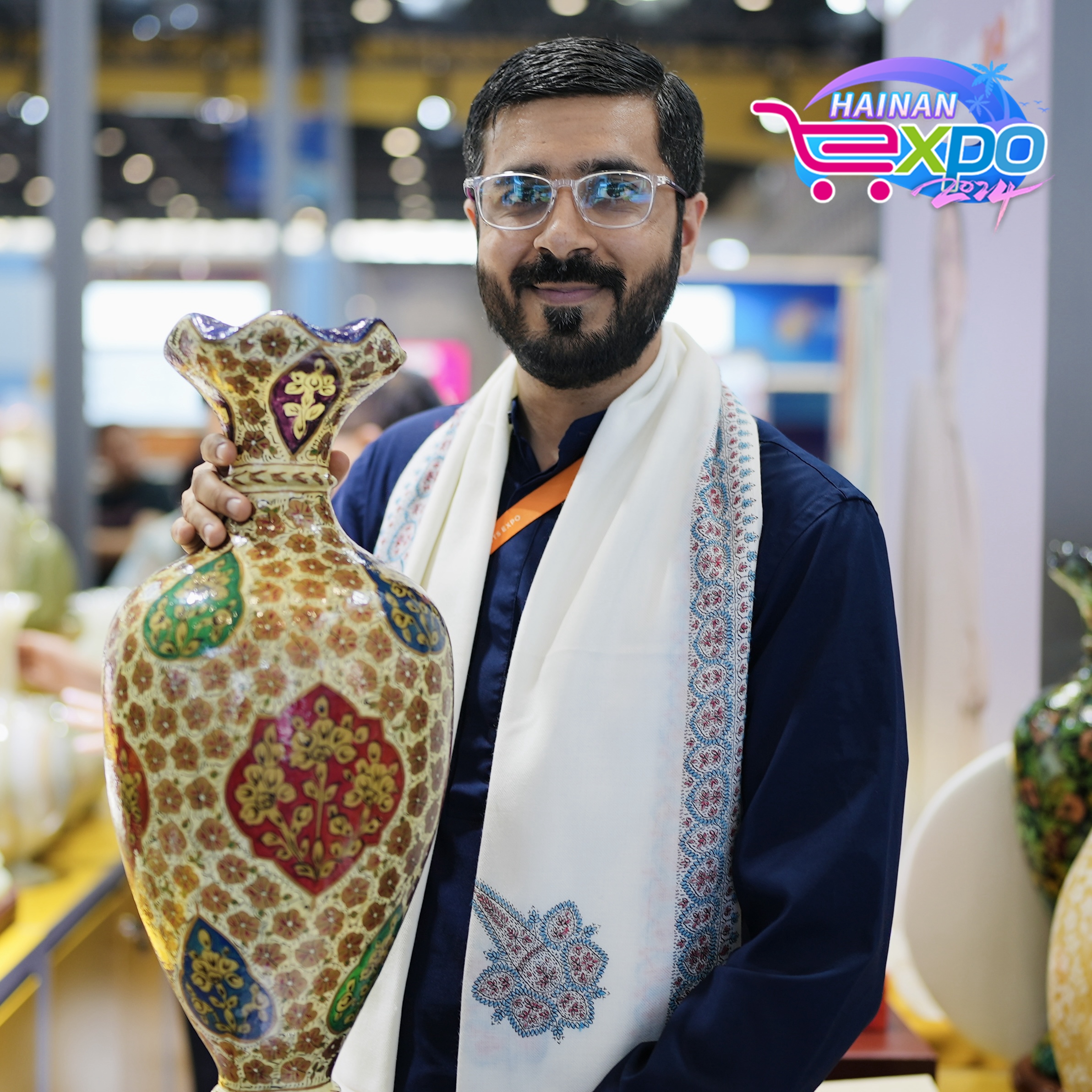 An exhibitor from Pakistan poses for a photo at the fourth China International Consumer Products Expo, Haikou City, south China's Hainan Province, April 16, 2024. Zhao Yuxiang/CGTN