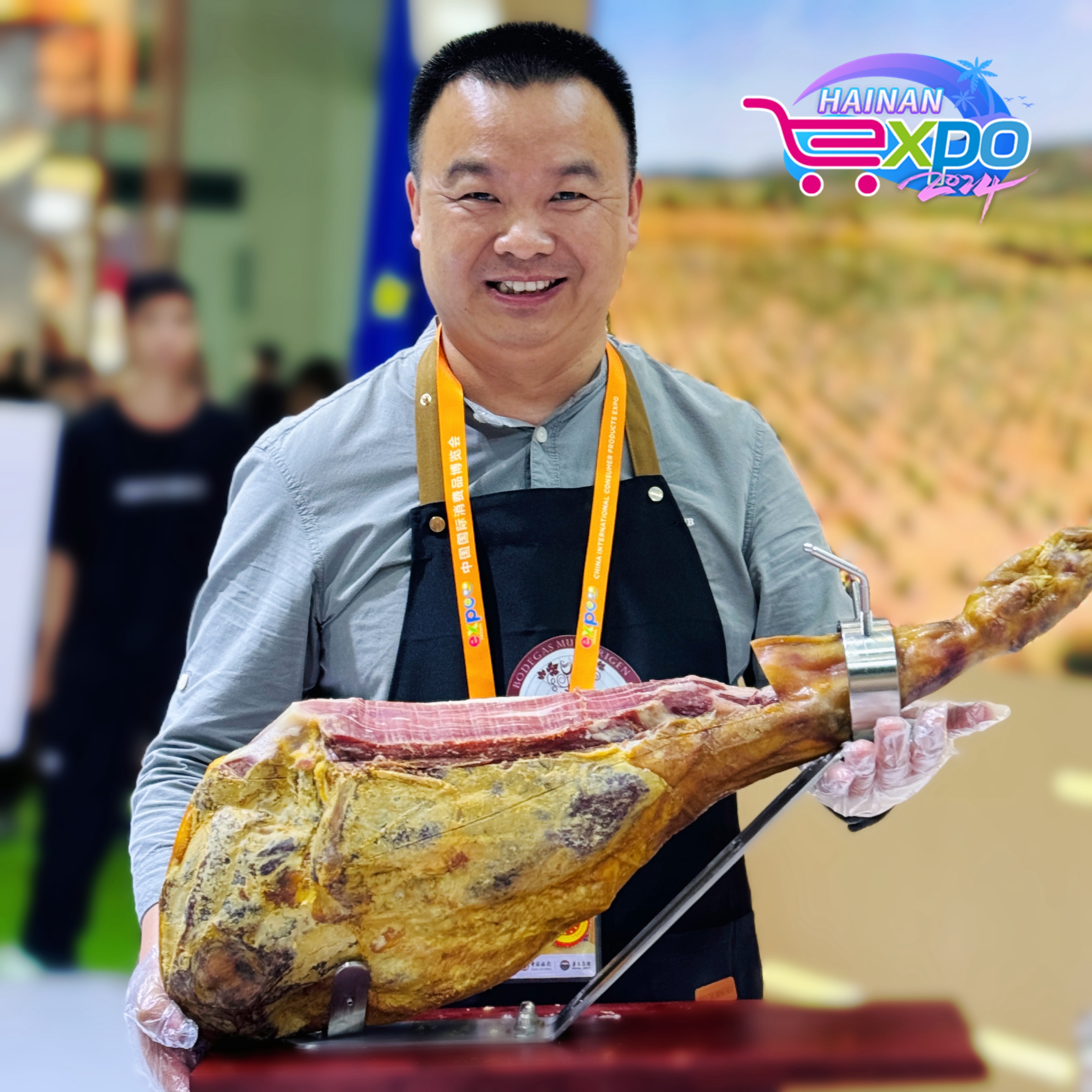 An exhibitor at the EU-China Geographical Indications booth poses for a photo at the fourth China International Consumer Products Expo, Haikou City, south China's Hainan Province, April 16, 2024. Guo Meiping/CGTN
