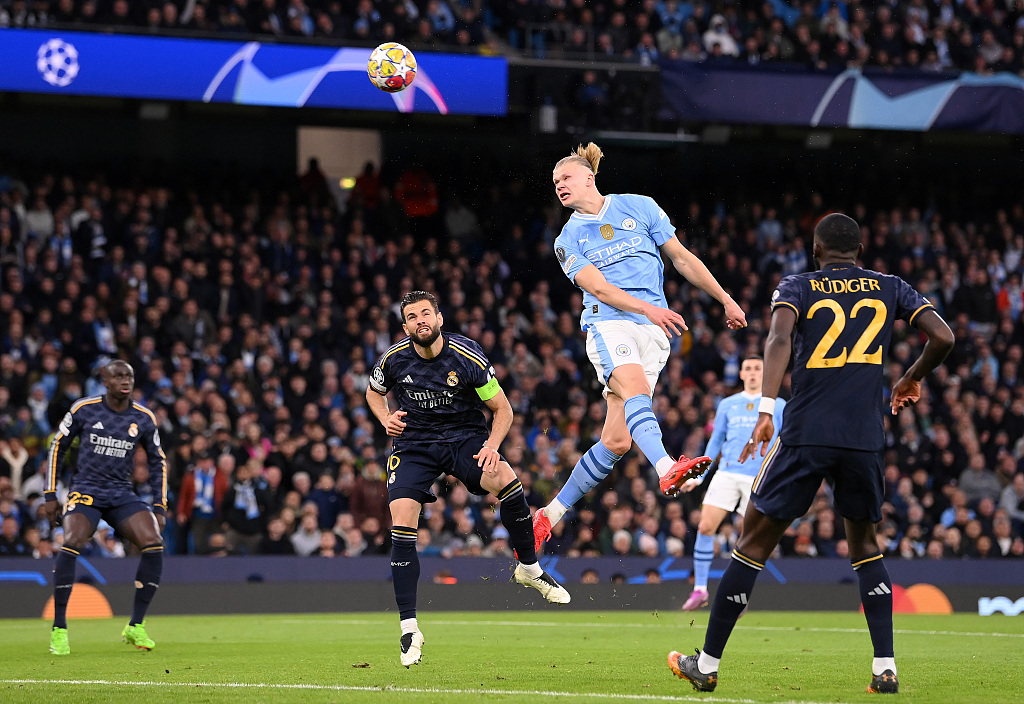 Erling Haaland of Manchester City heads over whilst under pressure during their Champions League clash with Real Madrid at the Etihad Stadium in Manchester, England, April 17, 2024. /CFP