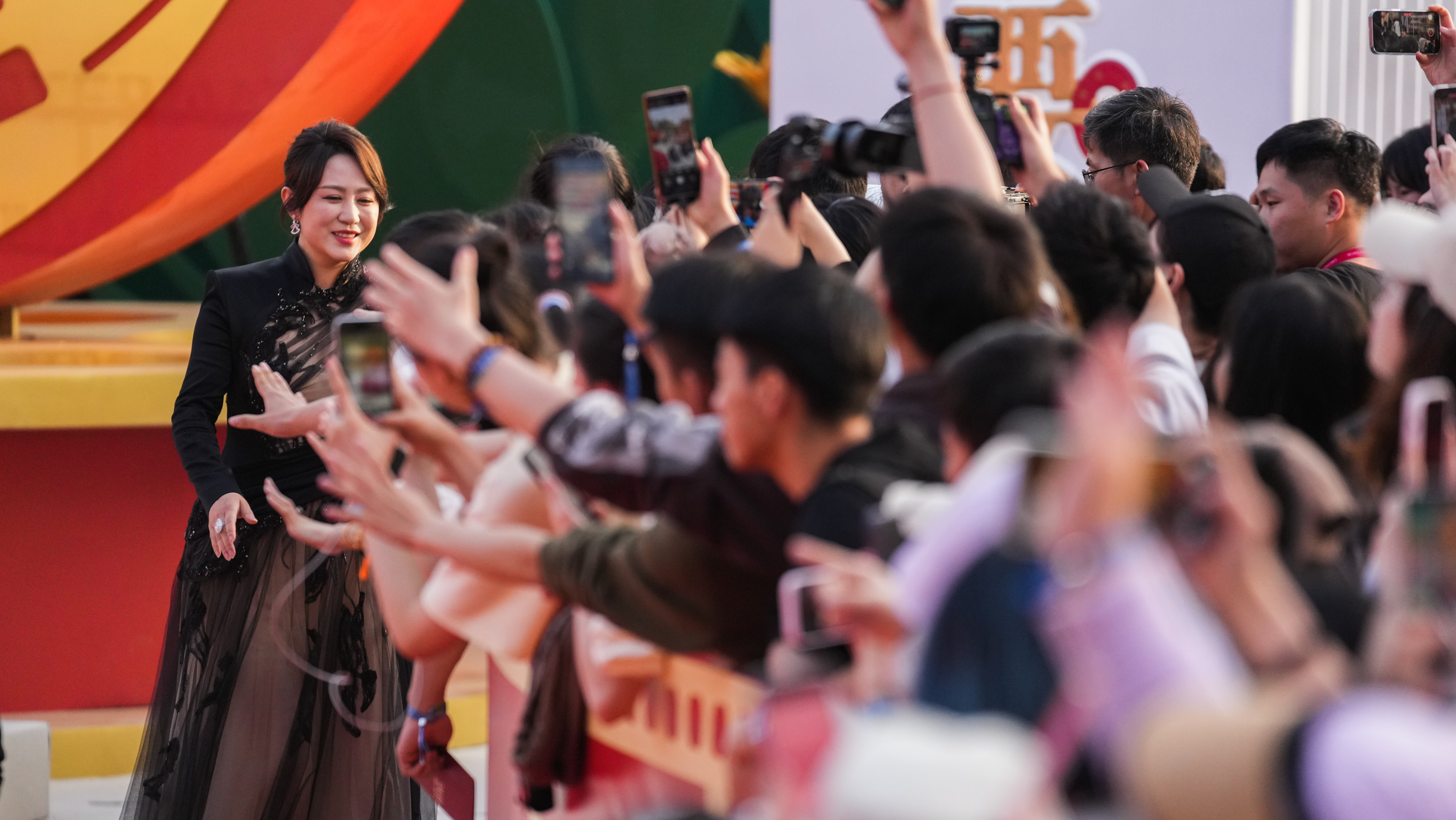 Ma Li, jury member of Tiantan Award, shakes hands with fans at the opening ceremony of the 14th Beijing International Film Festival in Beijing, April 18, 2024. Chen Bo/CGTN