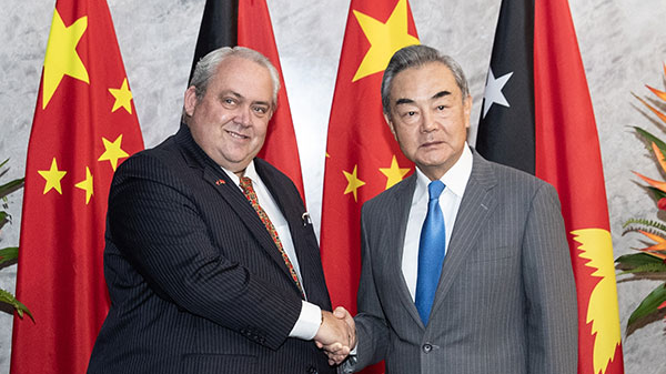 Chinese Foreign Minister Wang Yi (R), also a member of the Political Bureau of the Communist Party of China Central Committee, shakes hands with Papua New Guinea's Foreign Minister Justin Tkachenko in Port Moresby, Papua New Guinea, April 20, 2024. /Chinese Foreign Ministry