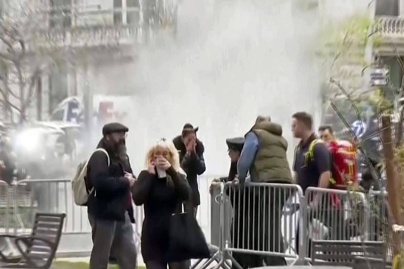 Bystanders react after witnessing a man who lit himself on fire was extinguished in a park outside Manhattan criminal court in New York, April 19, 2024. /CFP