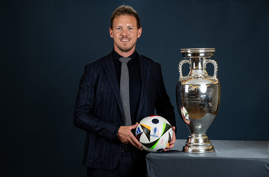 Julian Nagelsmann, manager of Germany, poses a photo with the UEFA European Championship trophy, Henri Delaunay Trophy, in Dusseldorf, Germany, April 8, 2024. /CFP