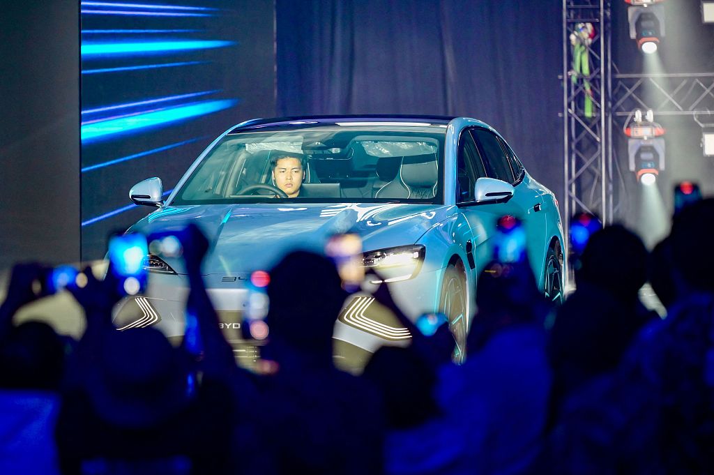 Chinese electric vehicle manufacturer BYD demonstrates its car as journalists record videos at a press conference in Jakarta, Indonesia, January 18, 2024. /CFP