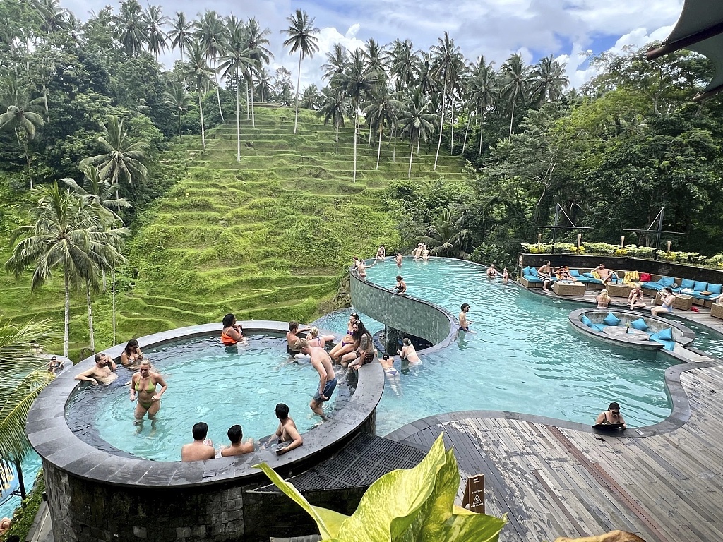 Tourists in a pool with a view of rice terraces, Bali, Indonesia, February 12, 2024. /CFP