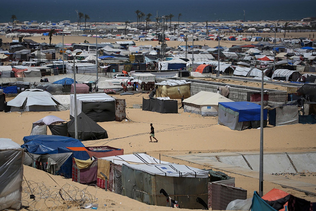 A man walks amid tents in a camp in Rafah in the southern Gaza Strip by the border with Egypt, April 28, 2024. /CFP