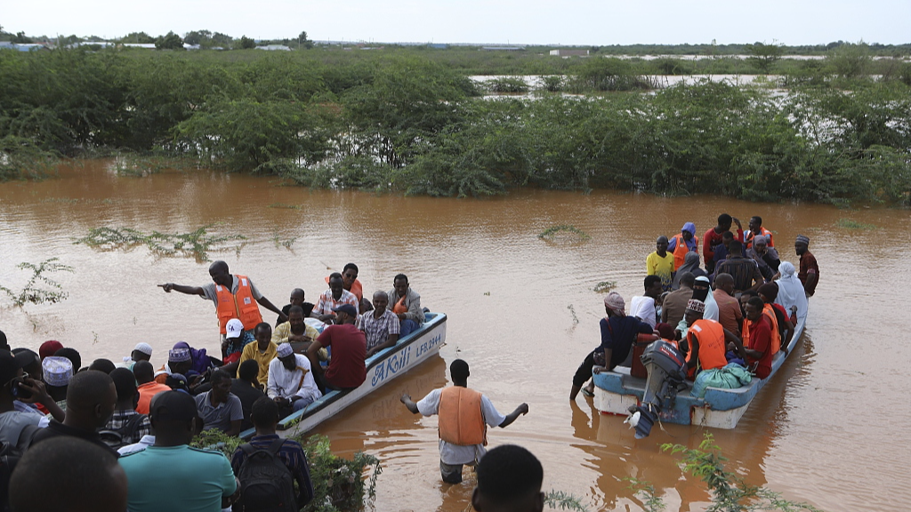 People cross a flooded area where another boat carrying a group of people capsized at Mororo, border of Tana River and Garissa counties, north eastern Kenya, April 28, 2024. /CFP