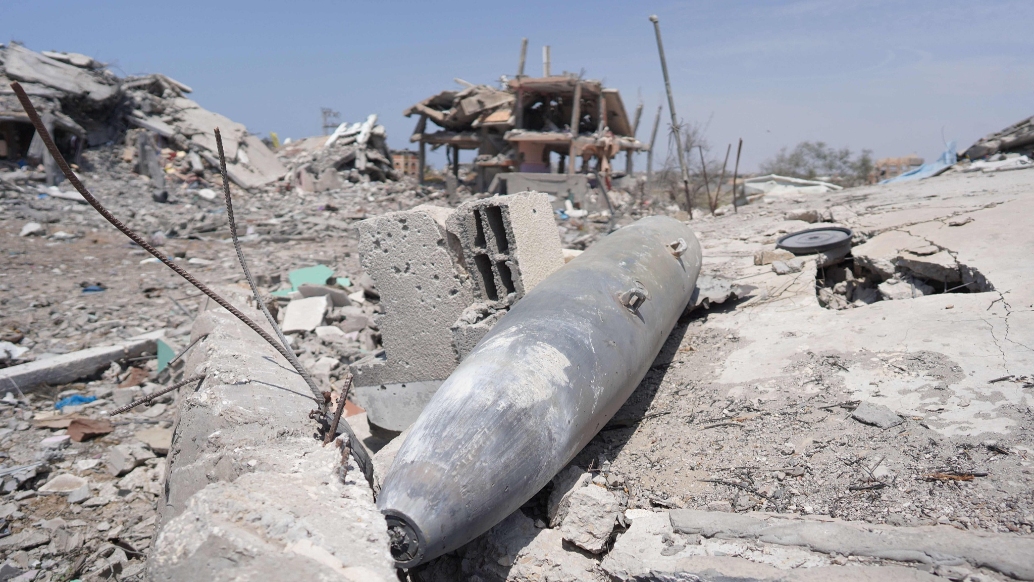 Parts of a missile lie amid debris of buildings destroyed during previous Israeli bombardment in Nuseirat in the central Gaza Strip, April 29, 2024. /CFP