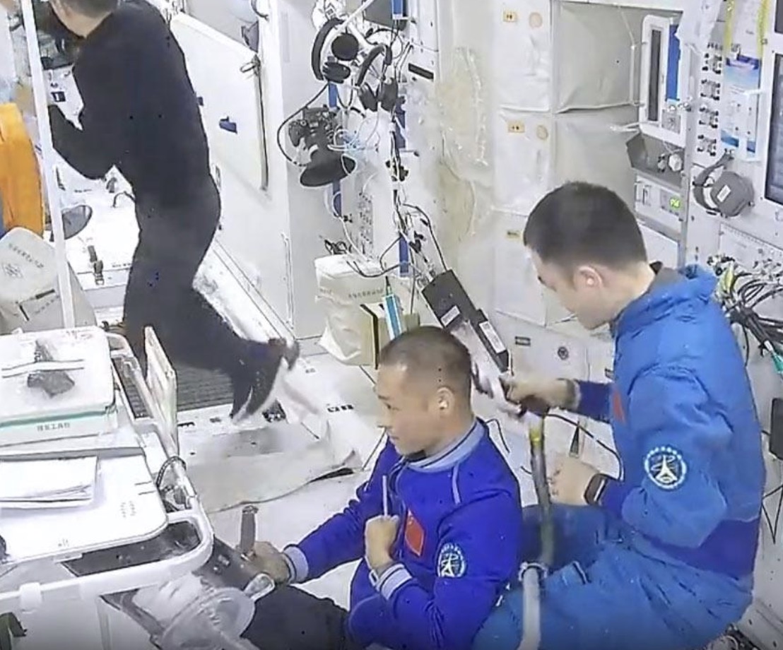 The Shenzhou-17 crew get haircuts in space. /CMG