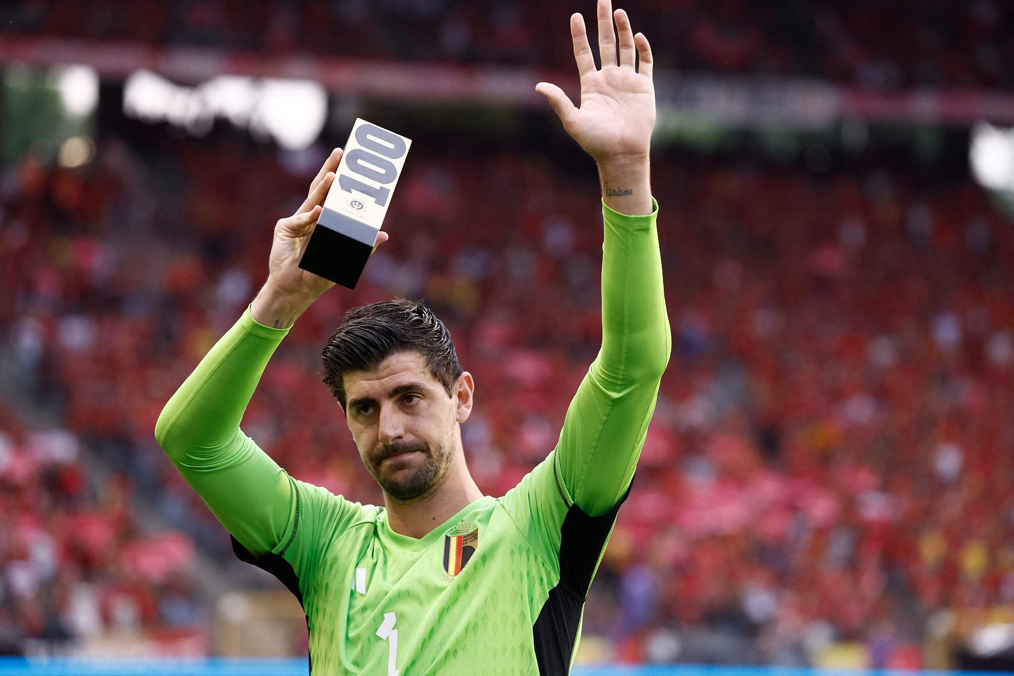 Belgium's goalkeeper Thibaut Courtois holds up a trophy as he celebrates his 100th match with the national team at the King Baudouin Stadium in Brussels, Belgium, June 17, 2023. /CFP