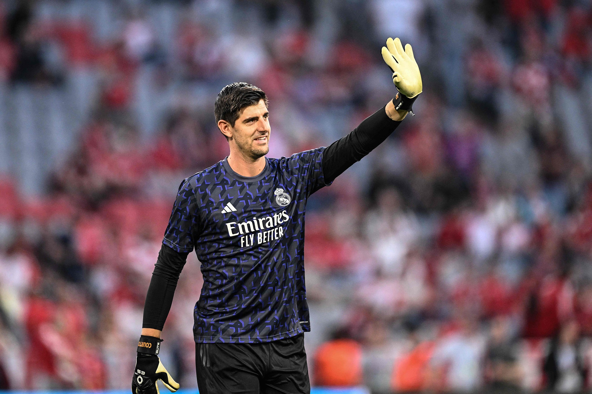 Real Madrid's goalkeeper Thibaut Courtois waves to fans ahead of their clash with Bayern Munich in Munich, Germany, April 30, 2024. /CFP