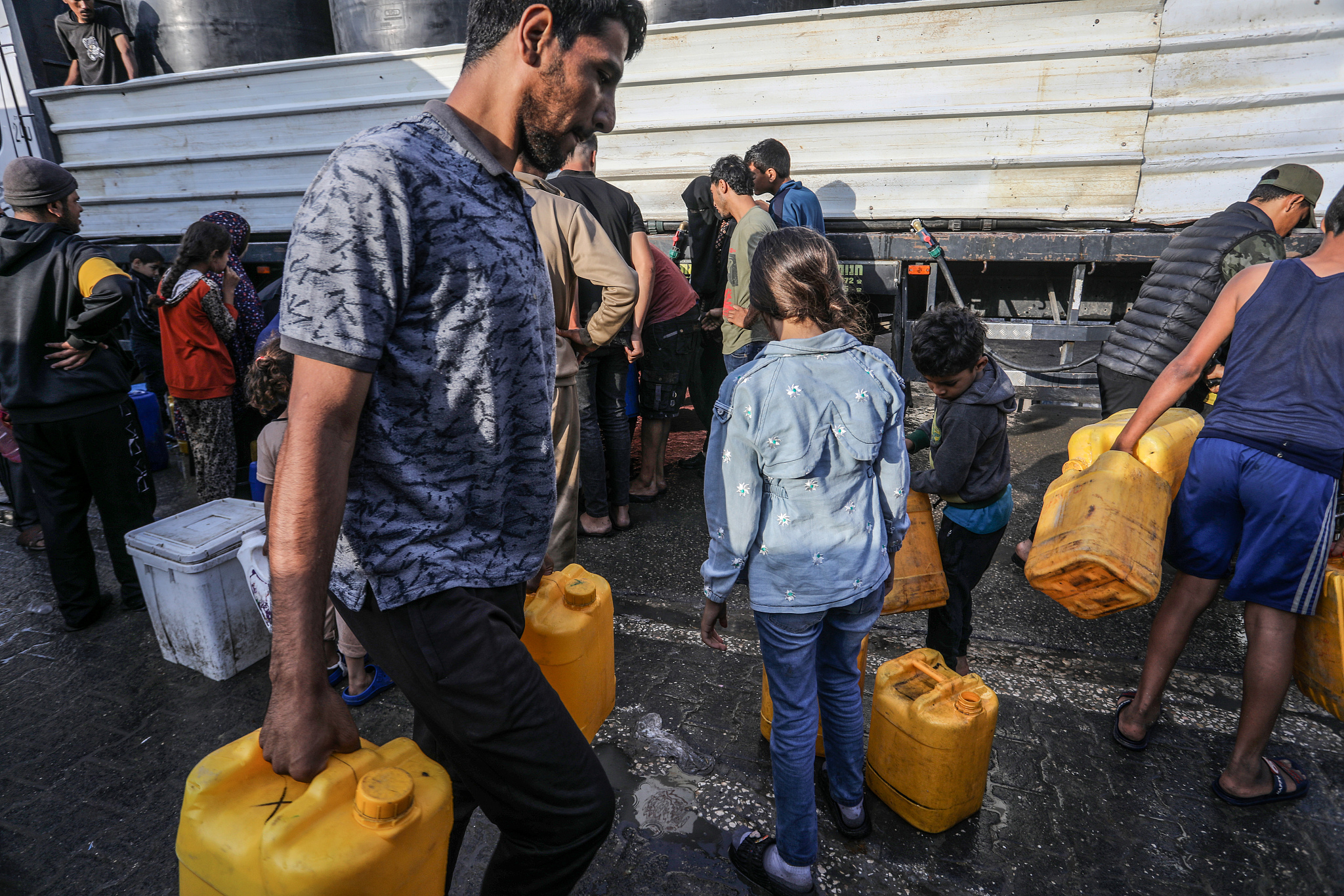 Palestinians, including children, struggle to provide water from mobile tanks to their families as Israeli attacks continue in Rafah, Gaza, April 30, 2024. /CFP