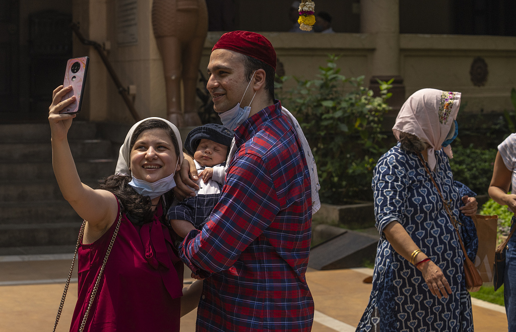 A Parsi (Zoroastrian) family takes selfie after offering prayers at a fire temple to mark the Parsi New Year, Nowruz, Mumbai, India, March 21, 2022. India hosts the world's largest Zoroastrian population, which relocated from their ancestral homeland of Persia to India due to religious persecution during the 8th to 10th centuries. /CFP
