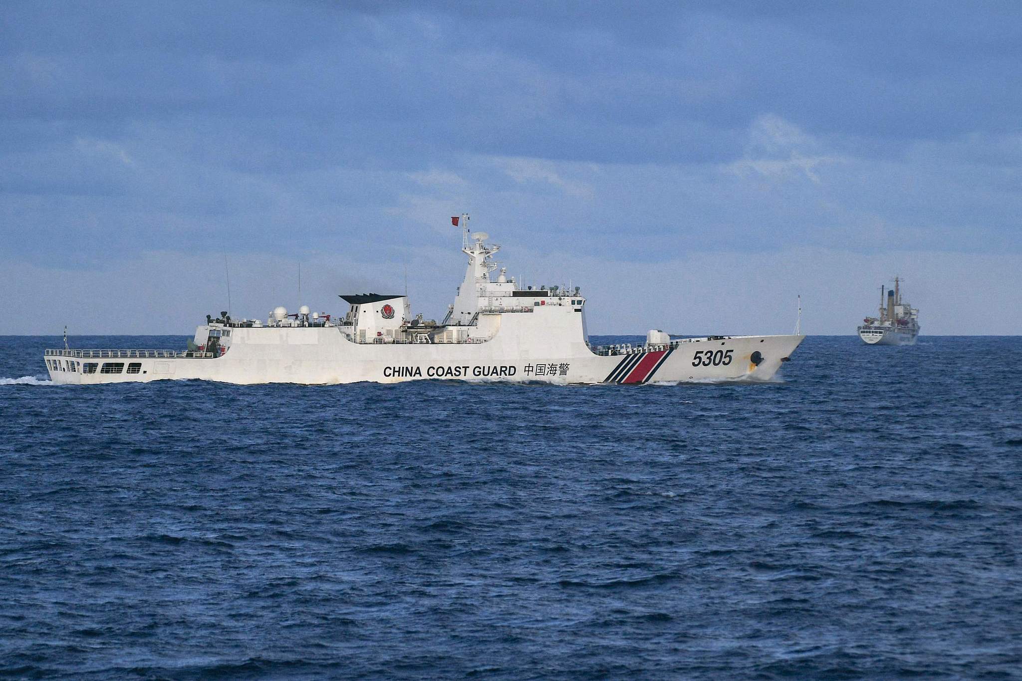 A Chinese Coast Guard ship sails near a Philippine vessel in the South China Sea, December 10, 2023. /CFP