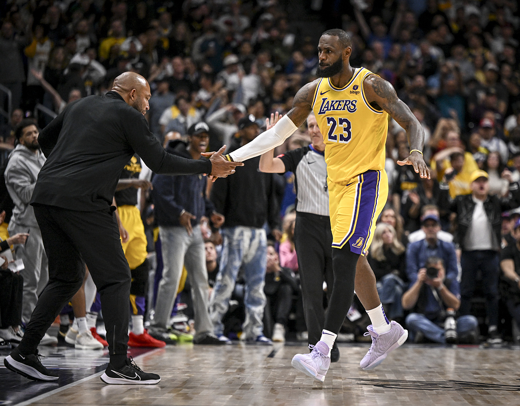 Darvin Ham (L), head coach of the Los Angeles Lakers, gives LeBron James a high five in Game 2 of the NBA Western Conference first-round playoffs against the Denver Nuggets at Ball Arena in Denver, Colorado, April 22, 2024. /CFP
