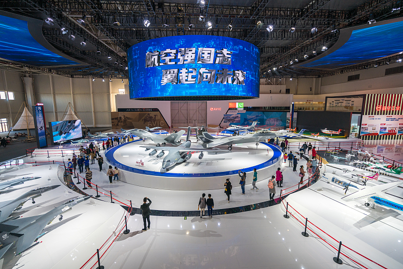Visitors take photos at an exhibition area at Zhuhai Aerospace Land, Zhuhai City, Guangdong Province. /CFP